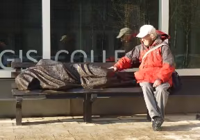 Homeless Jesus sculpture showing a figure sleeping on a bench